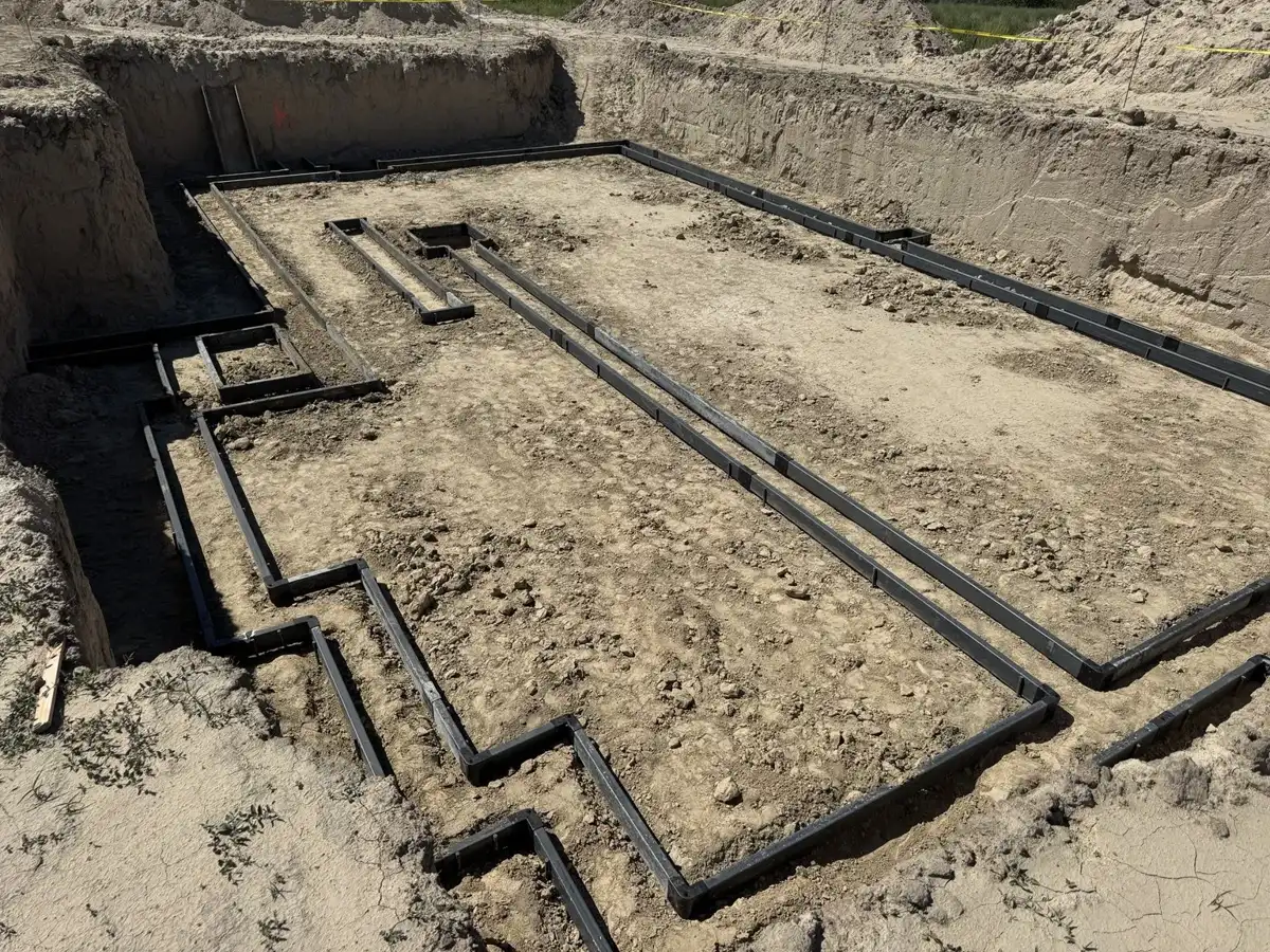 Foundation footing forms within basement excavation