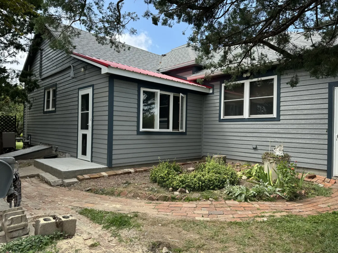 The porch addition takes shape alongside the updated siding and windows.