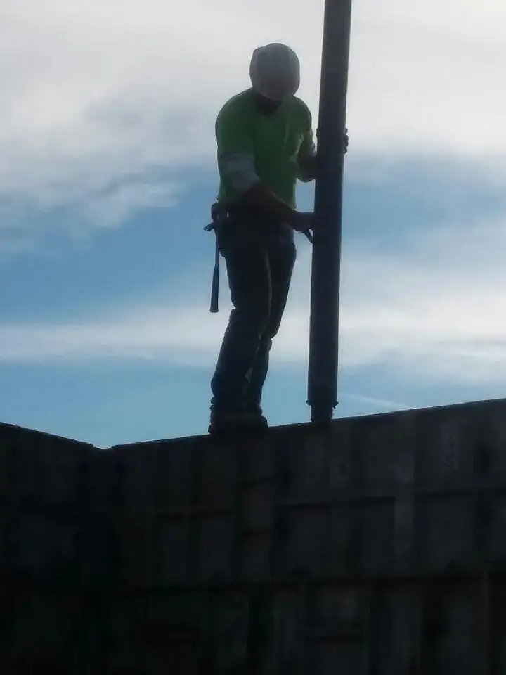 Concrete is placed into the wall forms using a pump hose.