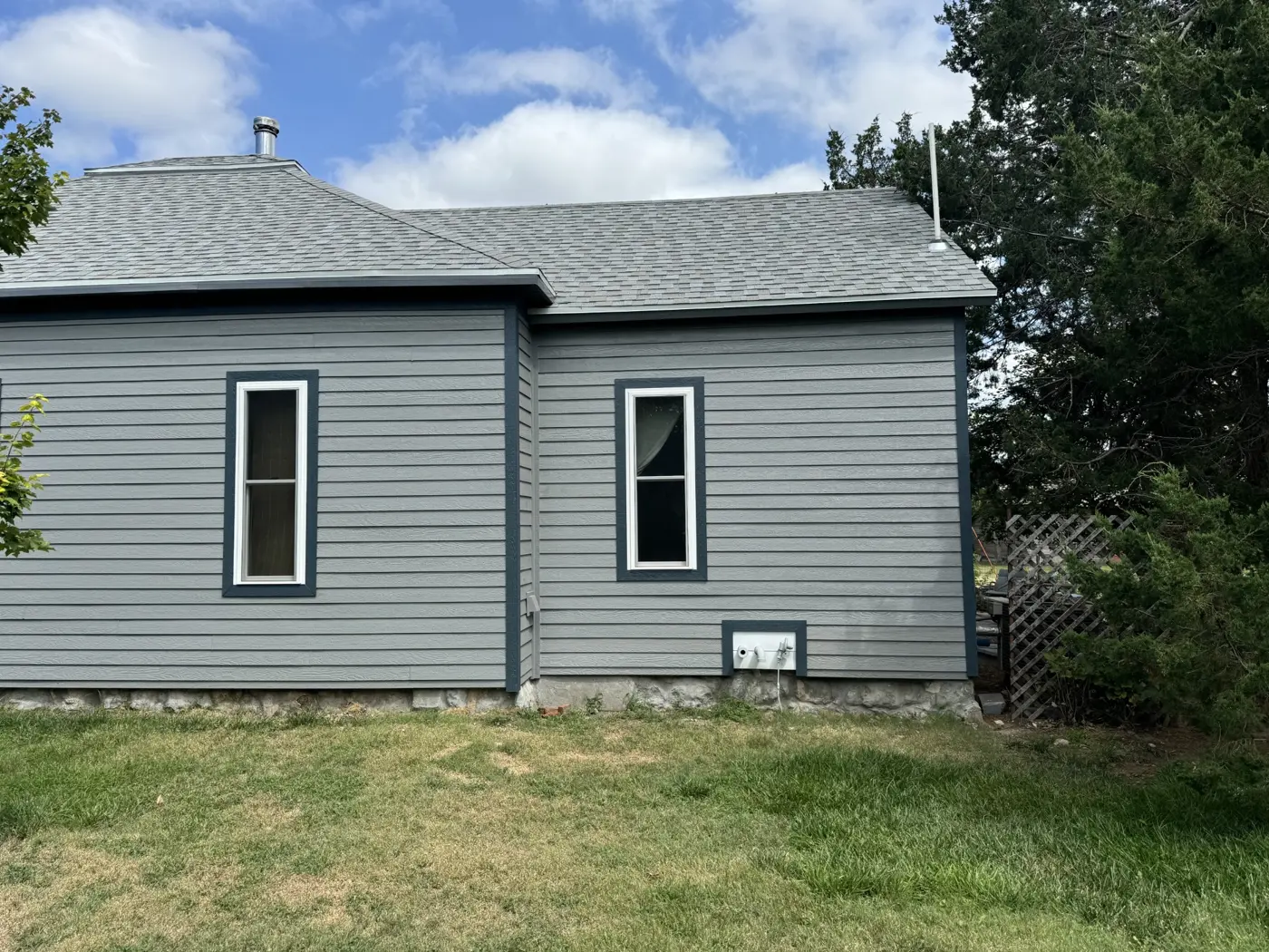 LP DiamondKote siding and contrasting window trim define the updated side elevation.
