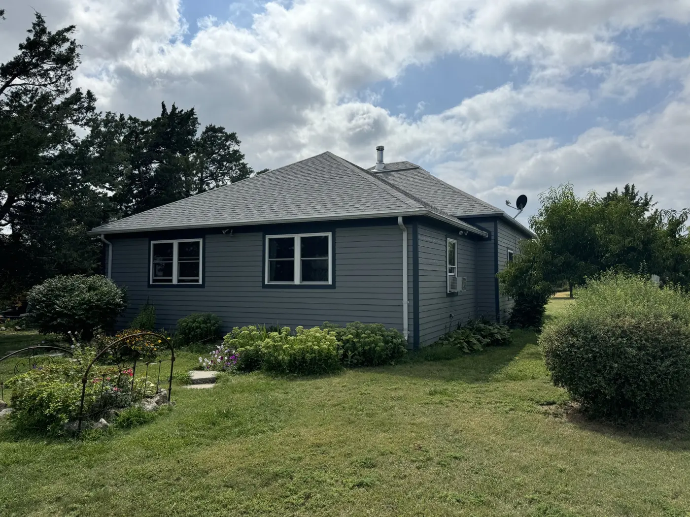 A wider view of the home with the new siding and windows in place.