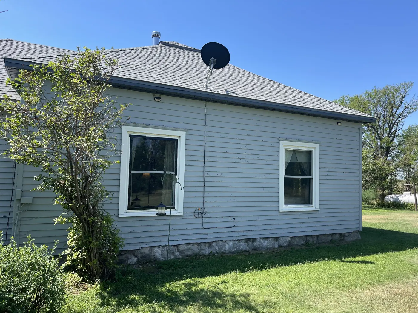 The original rear elevation before new siding, window, and trim work.