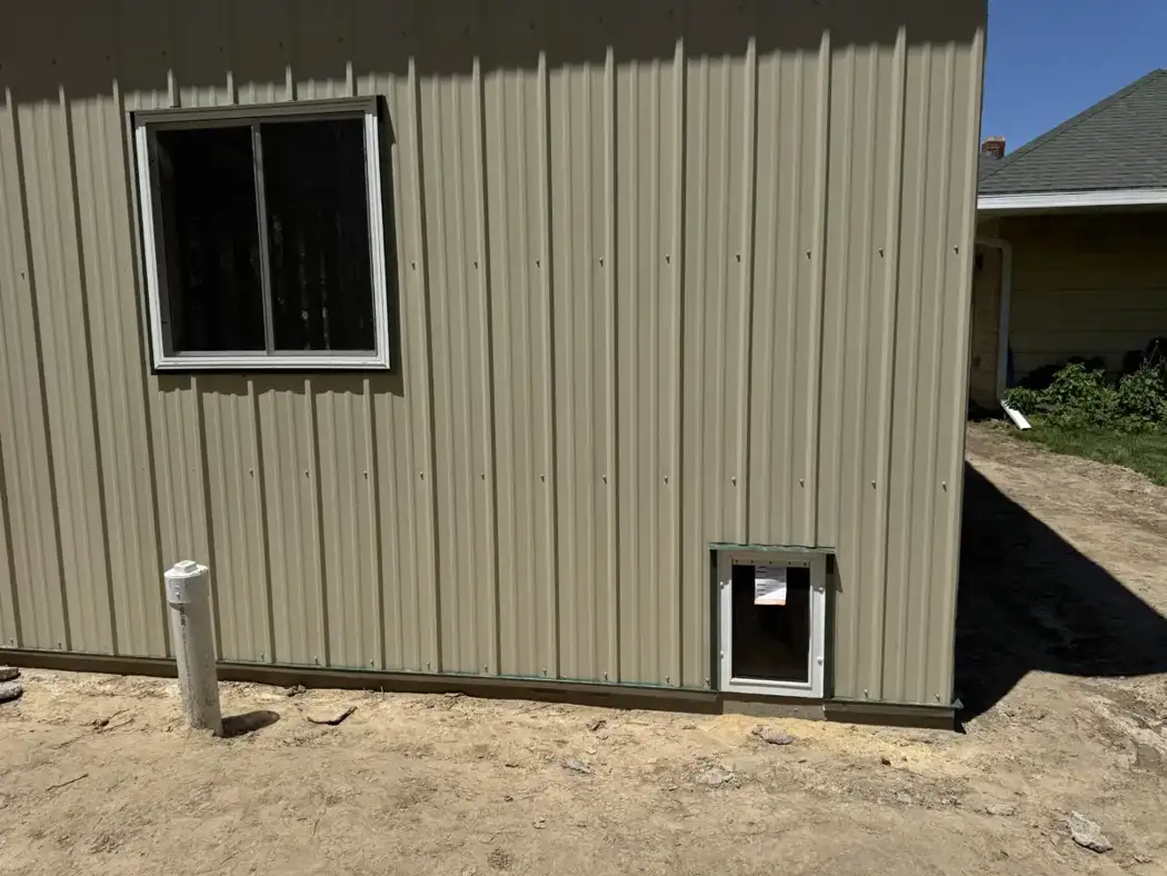 A window and lower wall opening are shown during exterior installation.