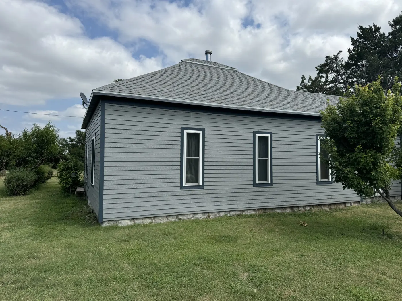 A corner view shows the coordinated siding, windows, and trim.