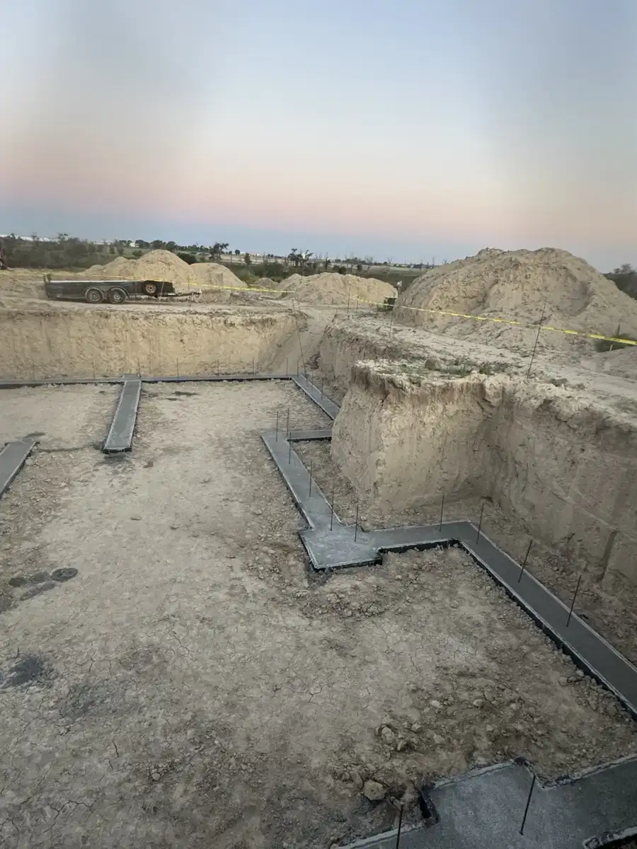 Poured concrete footings within excavated building footprint