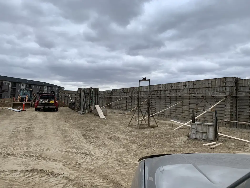 Foundation wall forms are aligned and supported by exterior braces before concrete placement.