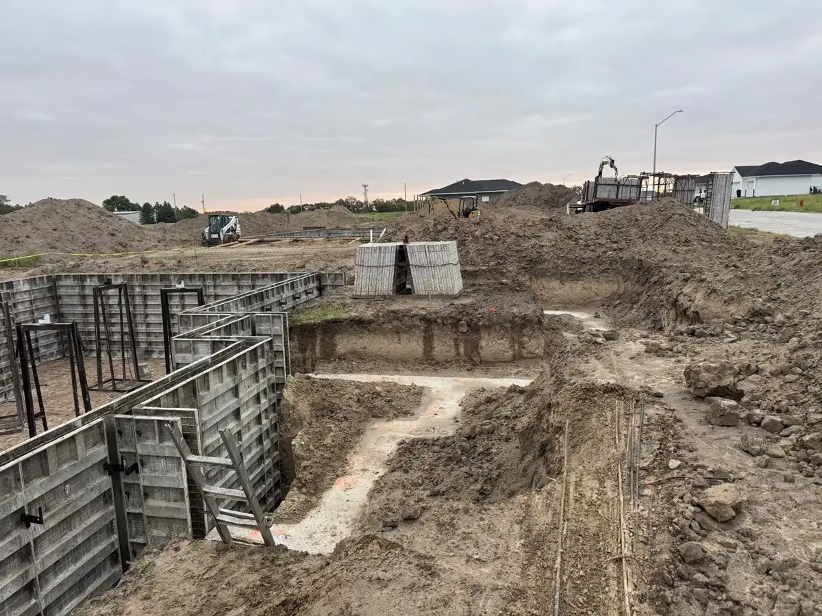 Foundation forms alongside excavated adjoining area