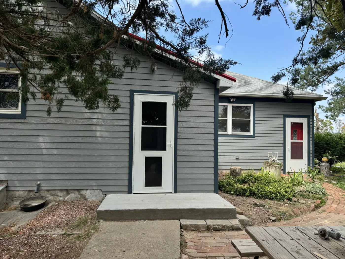 The porch entry features contrasting door trim and a concrete landing.