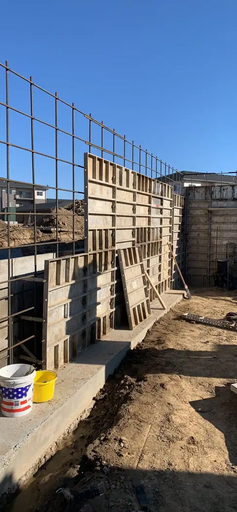 Vertical reinforcement and assembled forms prepare this wall section for concrete.