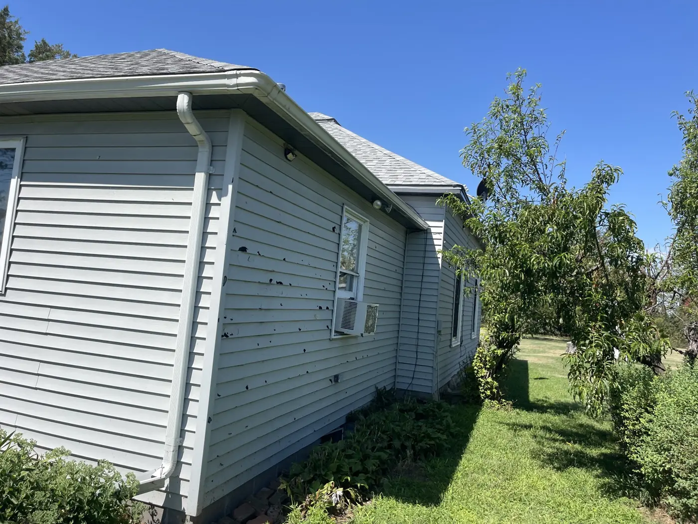 Original siding, windows, and corner details before the exterior renovation.