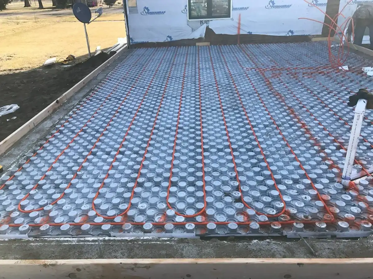 Close view of radiant floor heating tubing across insulated panels