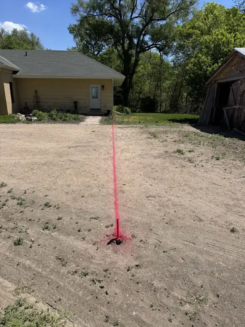 Layout markings establish the planned building footprint and its position beside the house.