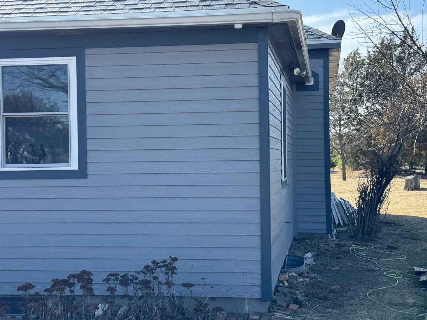 New siding and contrasting trim take shape at the corner of the house.