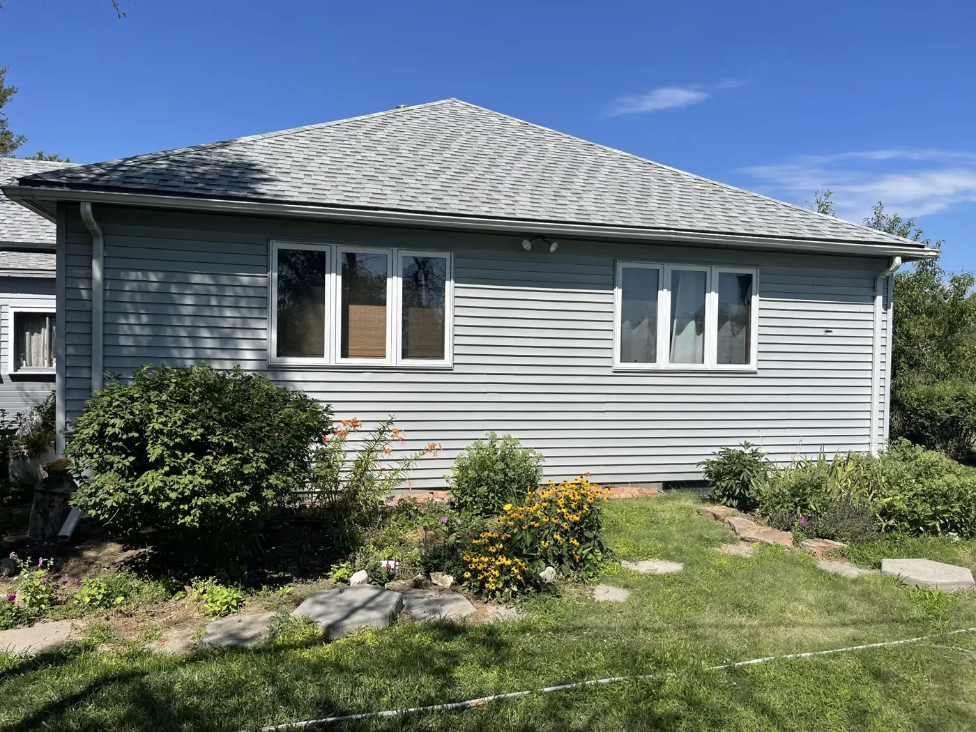 The original exterior before the siding, window, and porch improvements.